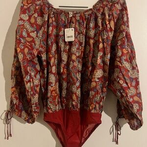 Free People body suit top. Size s adjustable wrist openings, wide neck.